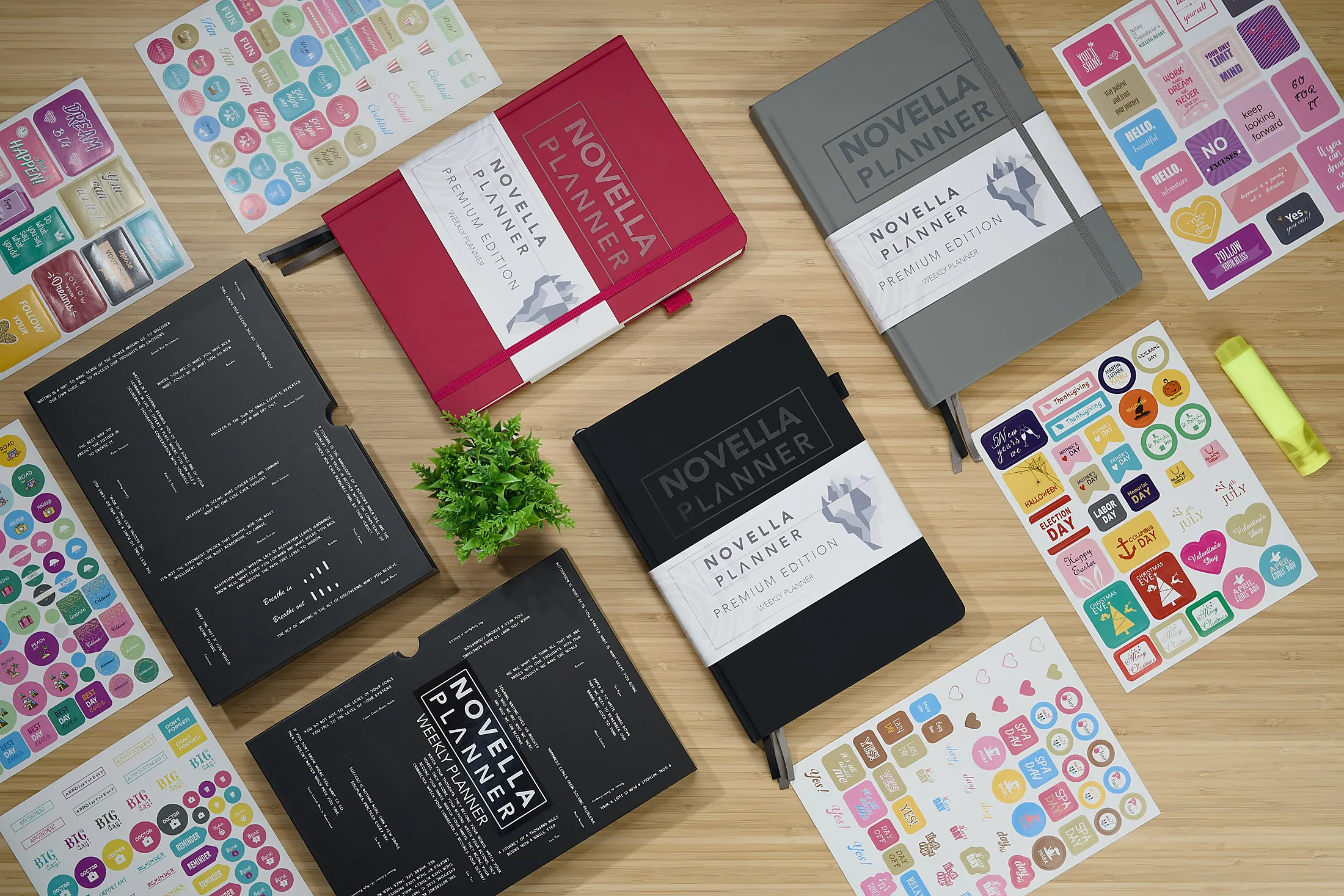 Red, black, and grey hardcover planners arranged on a clean tabletop